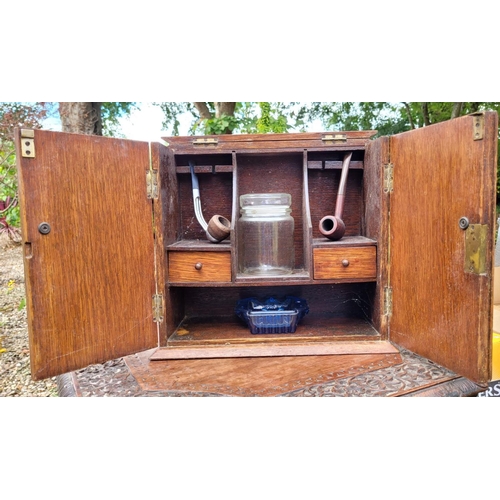 216 - A BRASS MOUNTED TWO DOOR TOBACOO / SMOKER’S CABINET, the top and front folds up and out to reveal co... 