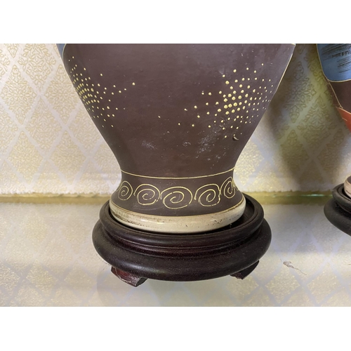 221 - A PAIR OF ANTIQUE JAPANESE SATSUMA VASES, baluster form, complete
with circular hardwood bases. Fine... 