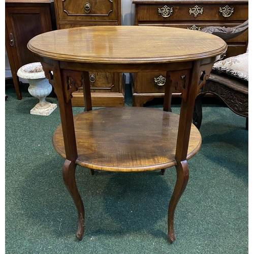 225 - A FINE TWO TIER MAHOGANY SIDE TABLE, oval top with carvings to supports, standing on cabriole leg. D... 