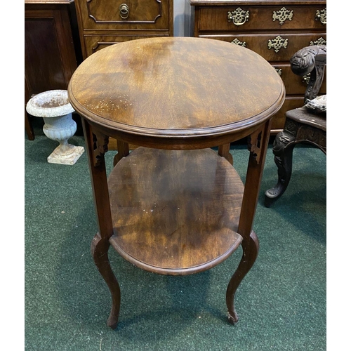 225 - A FINE TWO TIER MAHOGANY SIDE TABLE, oval top with carvings to supports, standing on cabriole leg. D... 