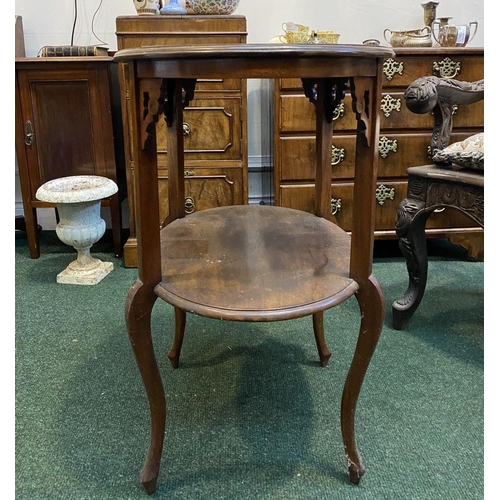 225 - A FINE TWO TIER MAHOGANY SIDE TABLE, oval top with carvings to supports, standing on cabriole leg. D... 