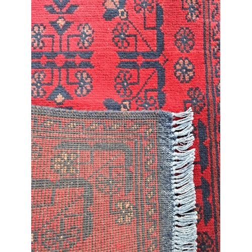 34 - A VERY GOOD QUALITY AFGHAN KHAN FLOOR RUG / RUNNER, with three floral medallions to the centre, surr... 