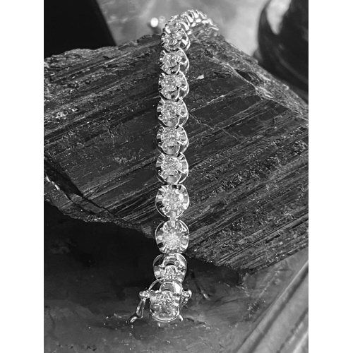 35 - A CLASSIC 18CT WHITE GOLD TENNIS BRACELET, claw set with 10.00cts of brilliant cut diamonds, colour:... 