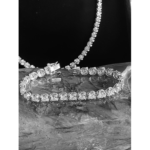 35 - A CLASSIC 18CT WHITE GOLD TENNIS BRACELET, claw set with 10.00cts of brilliant cut diamonds, colour:... 