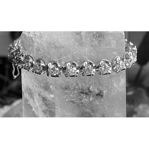 35 - A CLASSIC 18CT WHITE GOLD TENNIS BRACELET, claw set with 10.00cts of brilliant cut diamonds, colour:... 