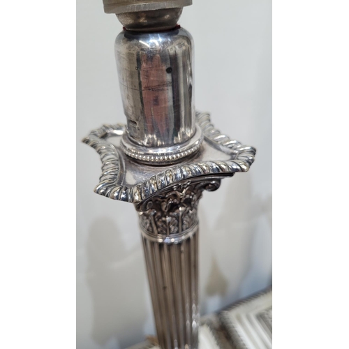 37 - A VERY FINE PAIR OF SILVER PLATED CORINTHIAN STYLE COLUMN TABLE LAMPS, each with adjustable height, ... 