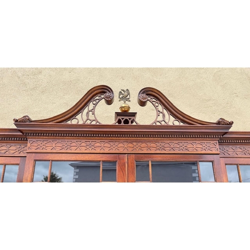 38 - A VERY FINE GOOD QUALITY MAHOGANY BREAK FRONT GLAZED LIBRARY BOOKCASE, to the top is a swan neck ped... 