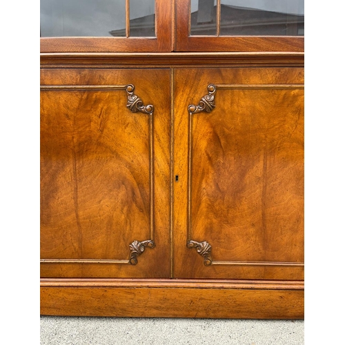 38 - A VERY FINE GOOD QUALITY MAHOGANY BREAK FRONT GLAZED LIBRARY BOOKCASE, to the top is a swan neck ped... 