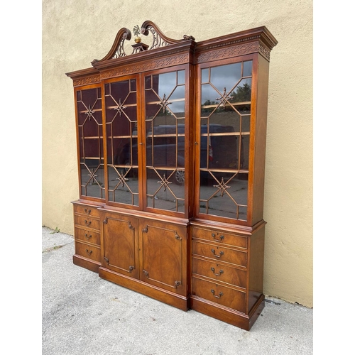 38 - A VERY FINE GOOD QUALITY MAHOGANY BREAK FRONT GLAZED LIBRARY BOOKCASE, to the top is a swan neck ped... 