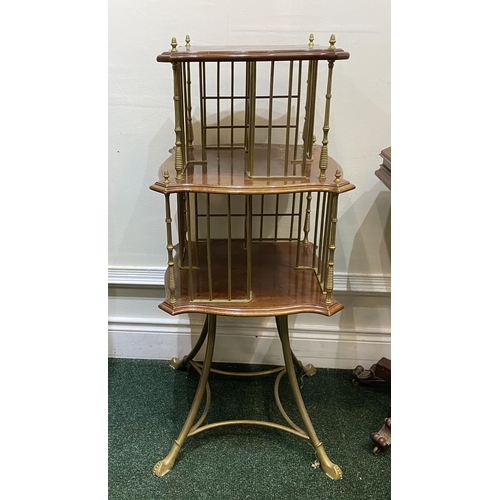 44 - AN ANTIQUE MAHOGANY AND BRASS REVOLVING BOOKCASE, with two shaped tiers supported by cast brass supp... 