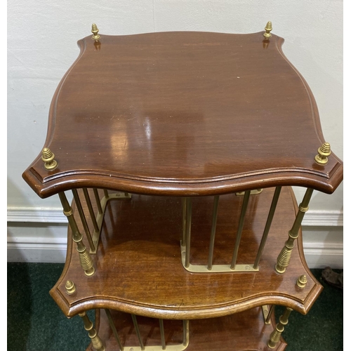 44 - AN ANTIQUE MAHOGANY AND BRASS REVOLVING BOOKCASE, with two shaped tiers supported by cast brass supp... 