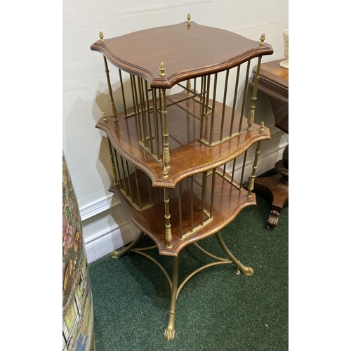 44 - AN ANTIQUE MAHOGANY AND BRASS REVOLVING BOOKCASE, with two shaped tiers supported by cast brass supp... 