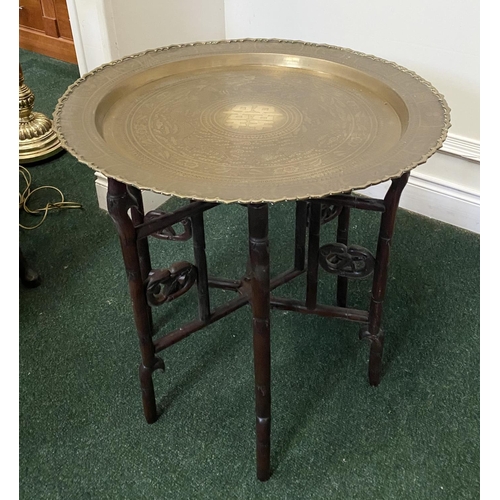 50 - AN ANTIQUE ANGLO/INDIAN FOLDING SIDE TABLE, brass embossed shaped circular top, with character mark ... 