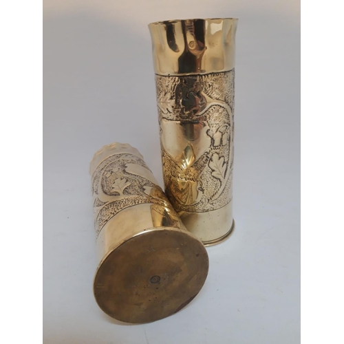 56 - A PAIR OF POLISHED BRASS WORLD WAR I TRENCH ART SHELLCASE VASES, dated 1917, decorated to the body w... 