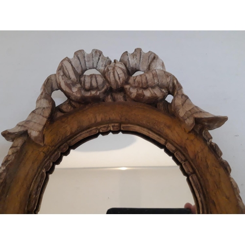 60 - A BEAUTIFUL CIRCULAR 19TH CENTURY CARVED WALL MIRROR, to the top a carved ribbon bowl, the frame wit... 