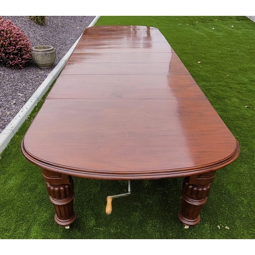 68 - A MAGNIFICENT MID 19TH CENTURY EXTENDING D-END MAHOGANY DINING TABLE, with moulded edging, standing ... 