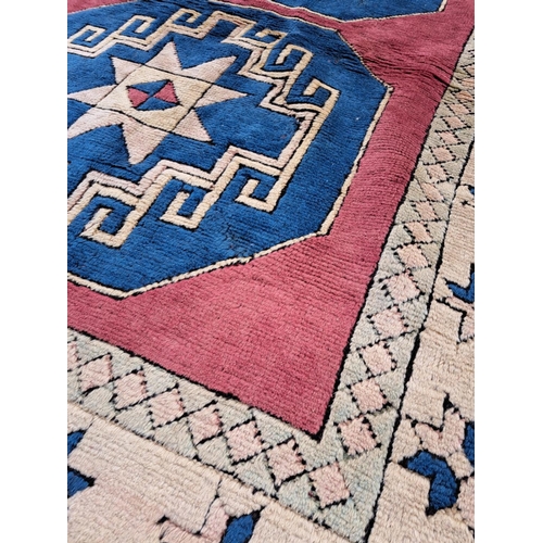 75 - A TRADITIONAL TURKISH ‘KARS’ FLOOR RUG, with double medallion design to the centre, having main grou... 