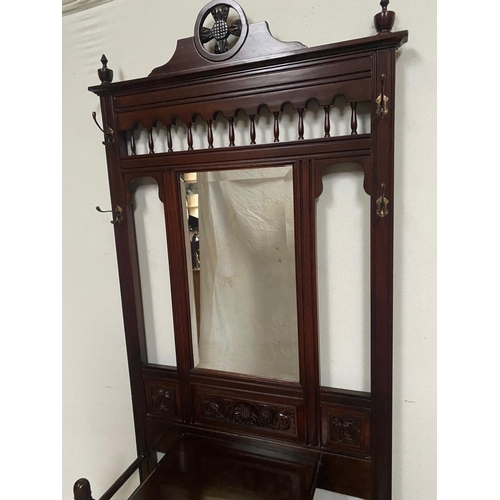 81 - A GOOD QUALITY TALL MIRROR BACKED HALL WAY STAND, with four coat hooks to the raised back gallery, 2... 