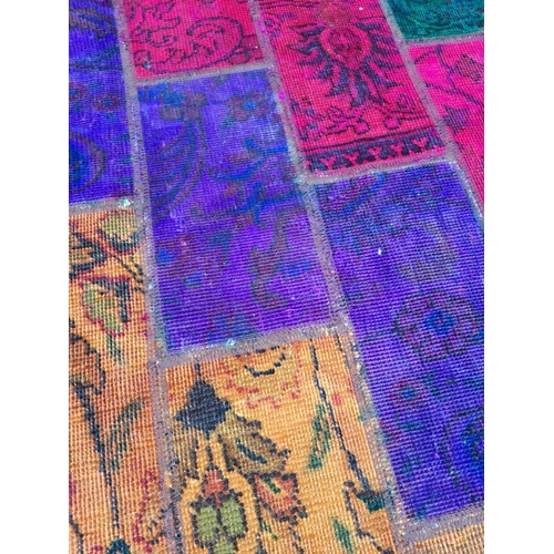 87 - A VIBRANT PERSIAN PATCHWORK RUG, featuring dyed patches of traditional Persian rugs in various desig... 