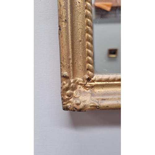 90 - AN ANTIQUE GILT PIER WALL MIRROR, 	with reverse painted picture panel to the top; showing a cottage ... 