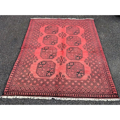 91 - A BEAUTIFUL TRADITIONAL AFGHAN AQCHA FLOOR RUG, with overall red ground colour, decorated with 8 med... 