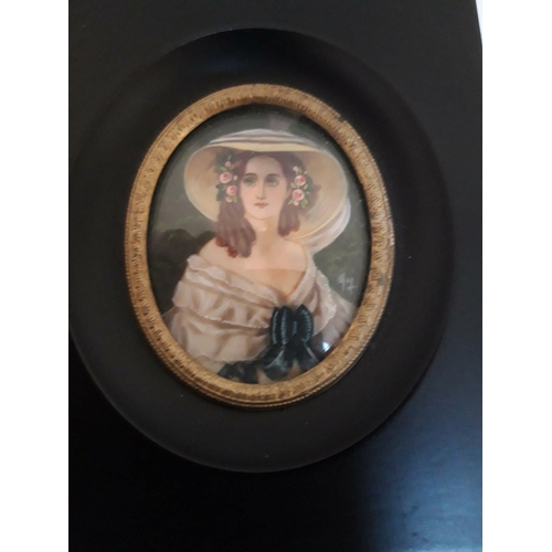 99 - A FRAMED MINIATURE OF A LADY, the ebonised frame with brass trim, lovely oval shaped miniature showi... 