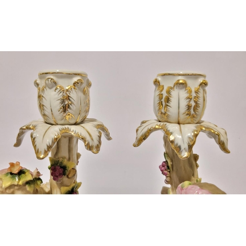 101 - A PAIR OF LATE 19TH / EARLY 20TH CENTURY CONTINENTAL PROCELAIN CANDLESTICKS, each with a figure hold... 