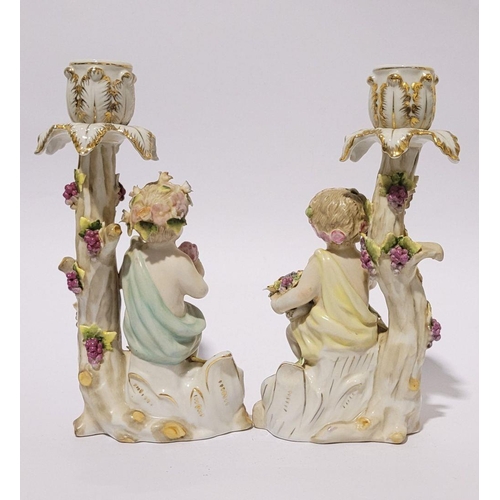 101 - A PAIR OF LATE 19TH / EARLY 20TH CENTURY CONTINENTAL PROCELAIN CANDLESTICKS, each with a figure hold... 