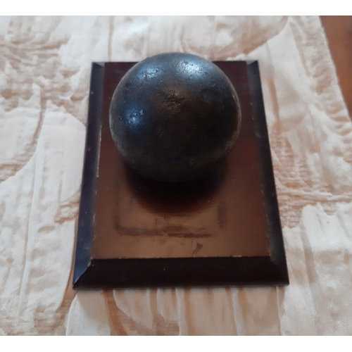 116 - A VINTAGE MOUNTED CANNON BALL ON MAHOGANY BASE, Dimensions: 4.5 x 3.5 inches, the cannon ball is two... 