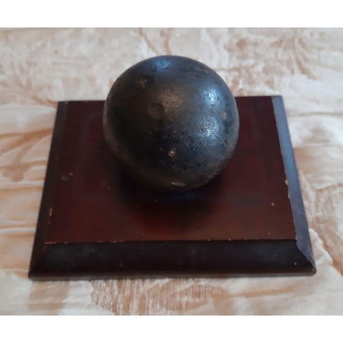 116 - A VINTAGE MOUNTED CANNON BALL ON MAHOGANY BASE, Dimensions: 4.5 x 3.5 inches, the cannon ball is two... 