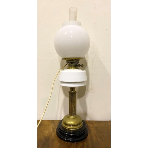 121 - A VINTAGE BRASS OIL LAMP, with two white glass shades, and chimney marked ‘Fire Proof’, with duplex ... 