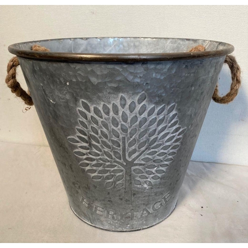 127 - A STEEL ASH BUCKET, with tree design in relief to front, with rope handles. Dimensions: 30cm high ap... 