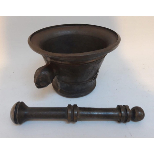 133 - A VINTAGE HEAVY CAST IRON MORTAR & PESTLE, with figural handles to wither side. Dimensions: mortar: ... 