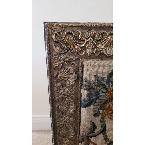 149 - AN ARTS N CRAFTS BRASS FRAMED FIRE SCREEN, the frame to the front with embossed floral & shell desig... 