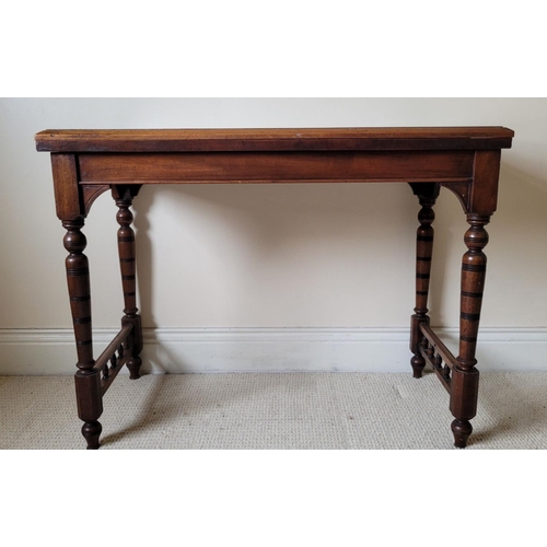 151 - AN ANTIQUE MAHOGANY FOLD OVER CARD TABLE, the top with a graduated edge that meets the frame beneath... 