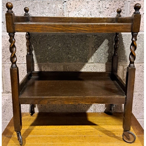 159 - AN ANTIQUE MAHOGANY DRINKS TROLLEY, with two tiers, twist supports with finials to top on castors. D... 