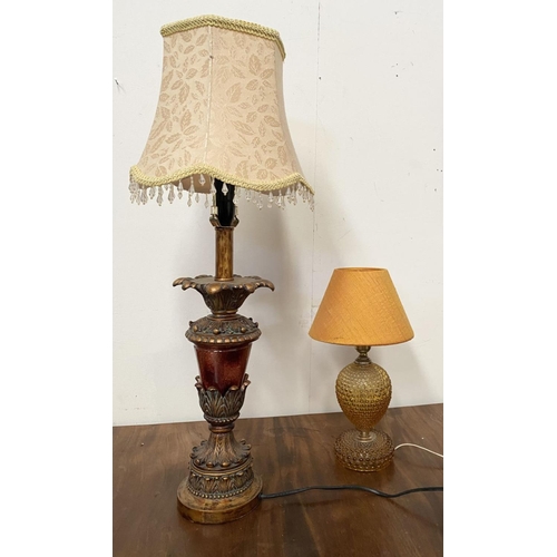 160 - A DECORATIVE AMBER GLASS GILT TABLE LAMP, with shaped support atop circular platform base and fringe... 