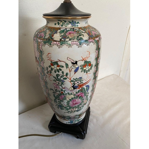26 - A CHINESE FAMILLE ROSE URN TABLE LAMP, decorated with painted figural panels surrounded by floral de... 