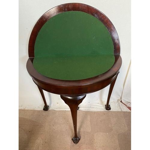 31 - A MAHOGANY HALF MOON CARD TABLE, with carving to edge, opening to green baize lined interior, standi... 