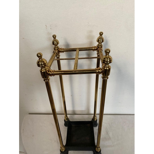 33 - A GOOD BRASS UMBRELLA/STICK STAND, polished brass with finials to top, supported by cast iron base. ... 