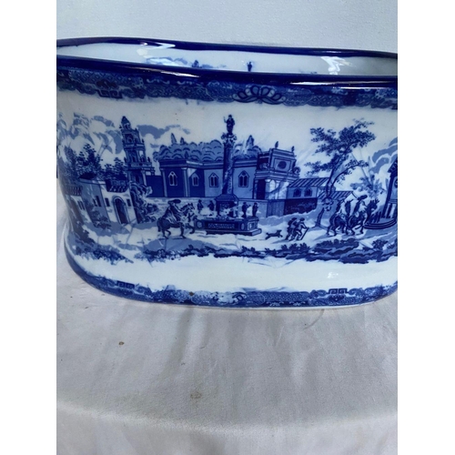 43 - A VINTAGE BLUE AND WHITE FOOTBATH/PLANTER, decorated with painted scenes surrounding, complete with ... 