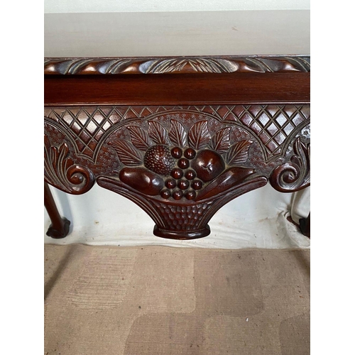 44 - AN IRISH STYLE MAHOGANY HALL TABLE, with carving to edge above decorative carved frieze with fruit b... 