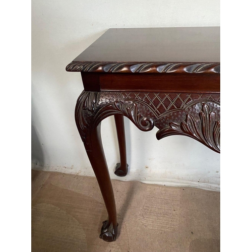 44 - AN IRISH STYLE MAHOGANY HALL TABLE, with carving to edge above decorative carved frieze with fruit b... 