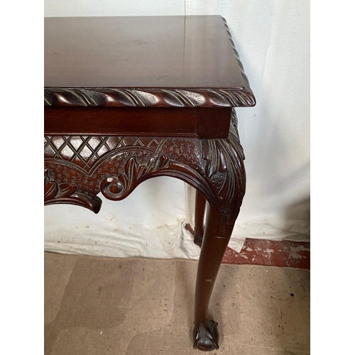 44 - AN IRISH STYLE MAHOGANY HALL TABLE, with carving to edge above decorative carved frieze with fruit b... 