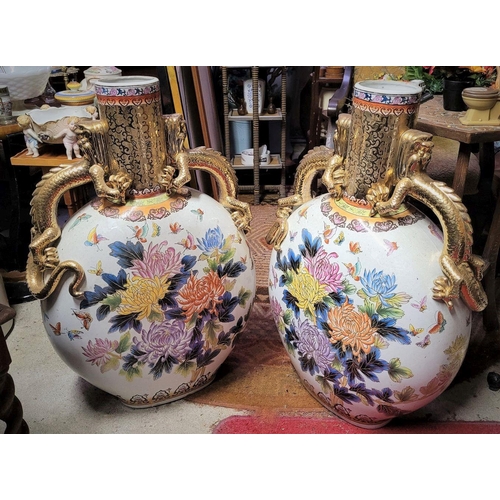 50 - A PAIR OF LARGE JAPANESE MOON FLASK VASES, each with a pair of detailed gilt dragon handles and flor... 