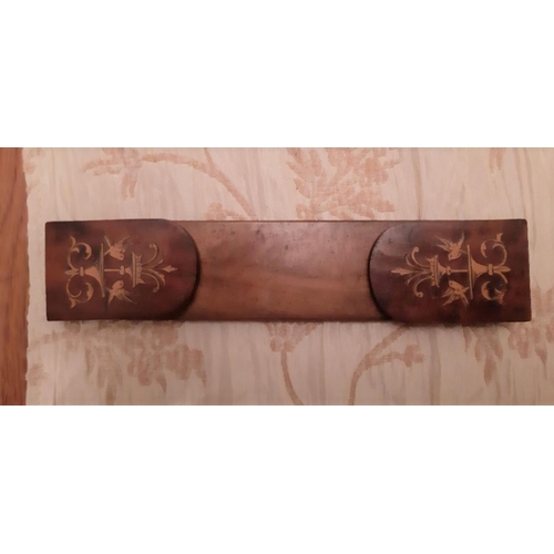 91 - AN EDWARDIAN INLAID WALNUT BOOK SLIDE, the hinged side book supports are decorated with foliage desi... 