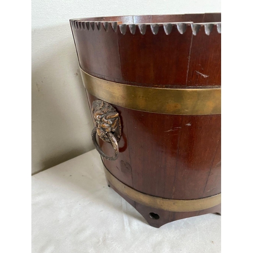 96 - AN IRISH MAHOGANY BRASS BOUND JARDINIERE, carving to top, with two brass bindings, as well as two li... 