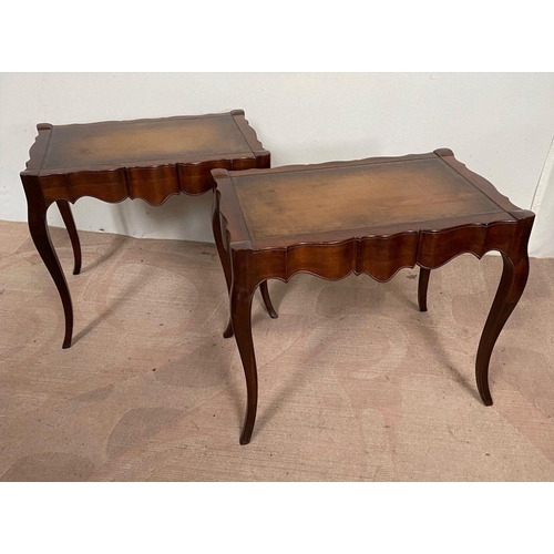 104 - A PAIR OF MAHOGANY SHAPED LEATHER TOPPED COFFEE TABLES, shaped top with leather inset, both standing... 