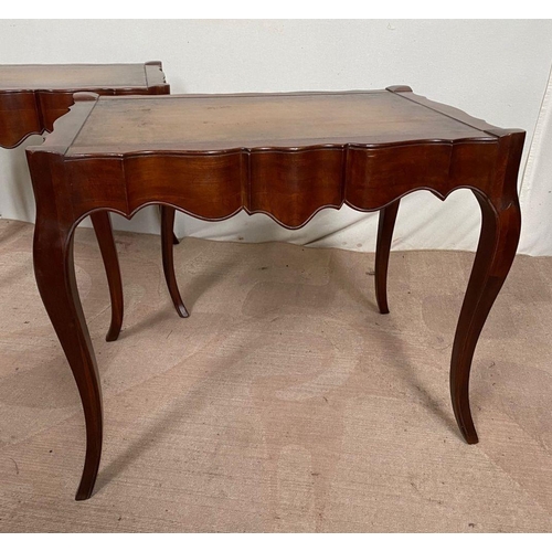 104 - A PAIR OF MAHOGANY SHAPED LEATHER TOPPED COFFEE TABLES, shaped top with leather inset, both standing... 