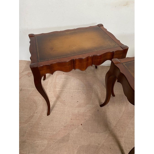 104 - A PAIR OF MAHOGANY SHAPED LEATHER TOPPED COFFEE TABLES, shaped top with leather inset, both standing... 